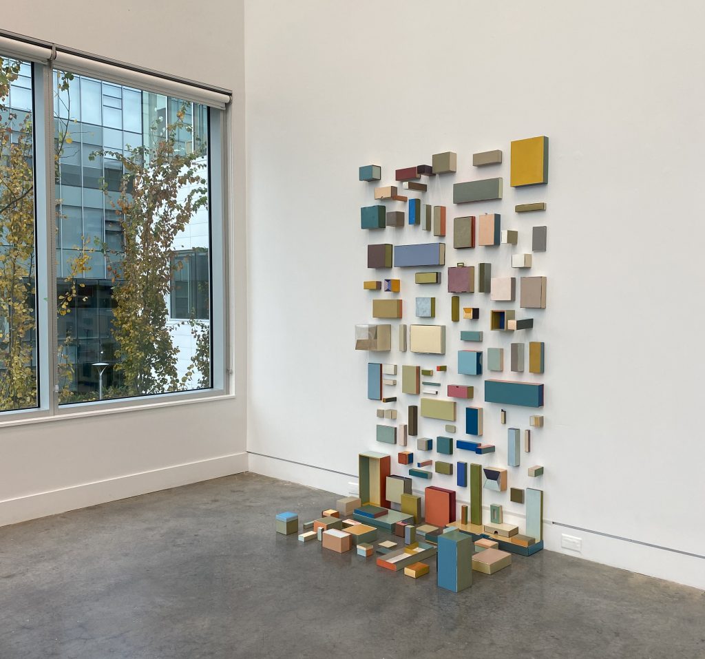 wall based installation comprised of 117 oil painted boxes