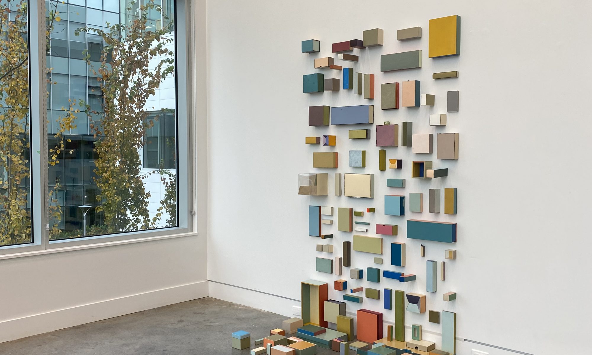 wall based installation comprised of 117 oil painted boxes